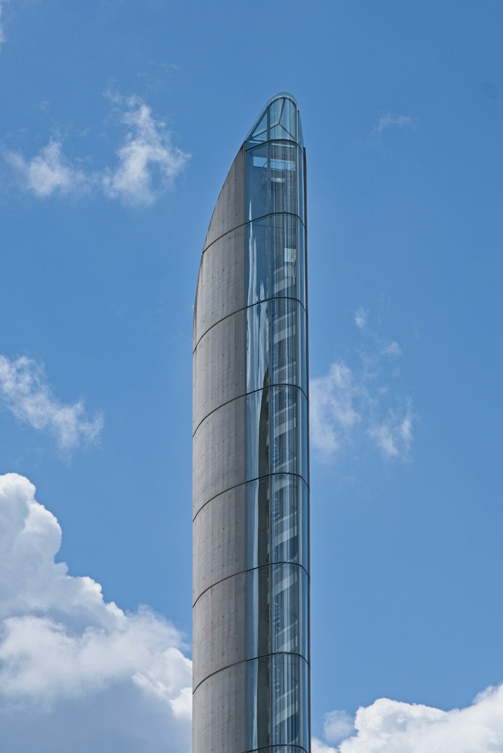 a tall building with a curved glass front
