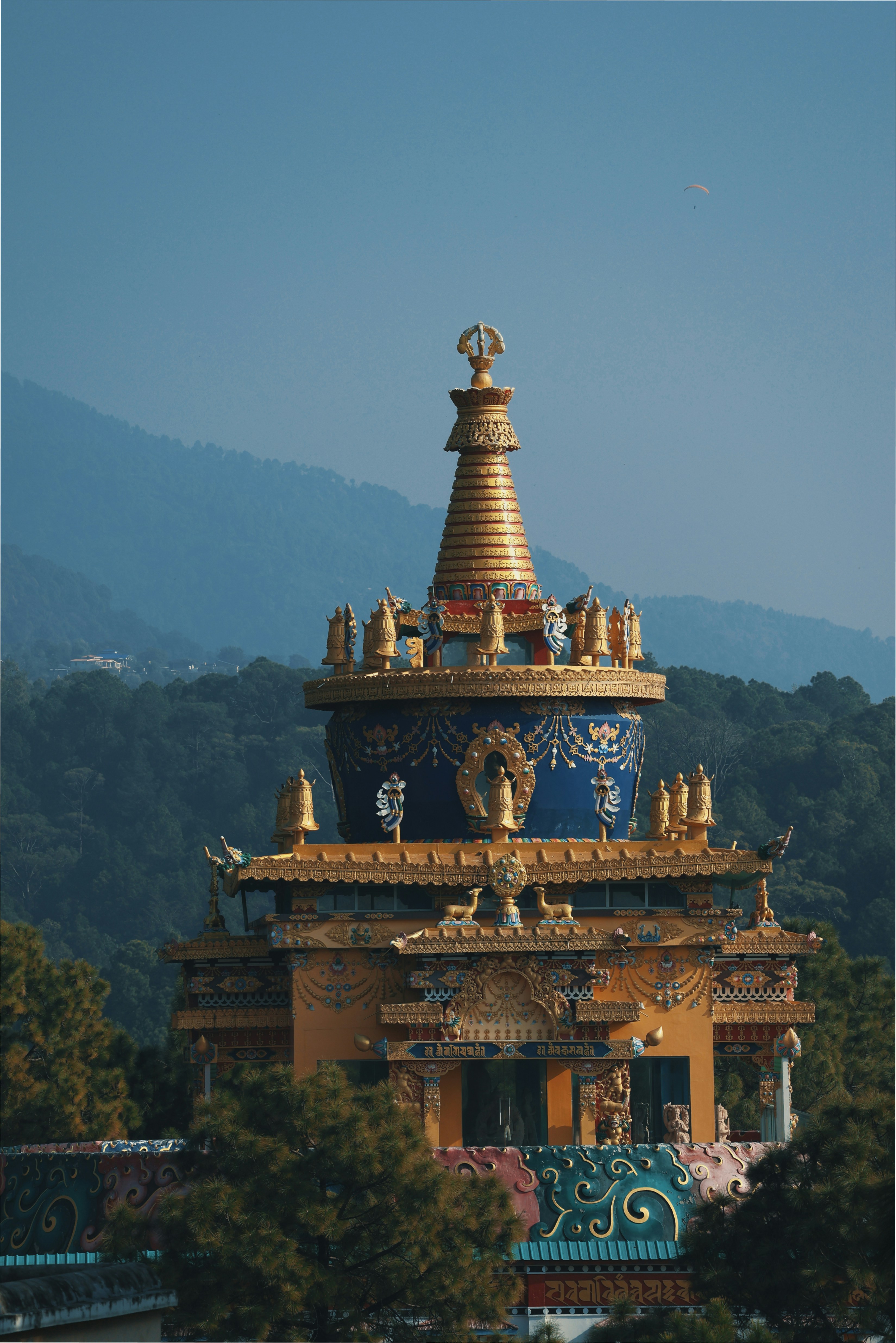 a golden and blue building with a mountain in the background