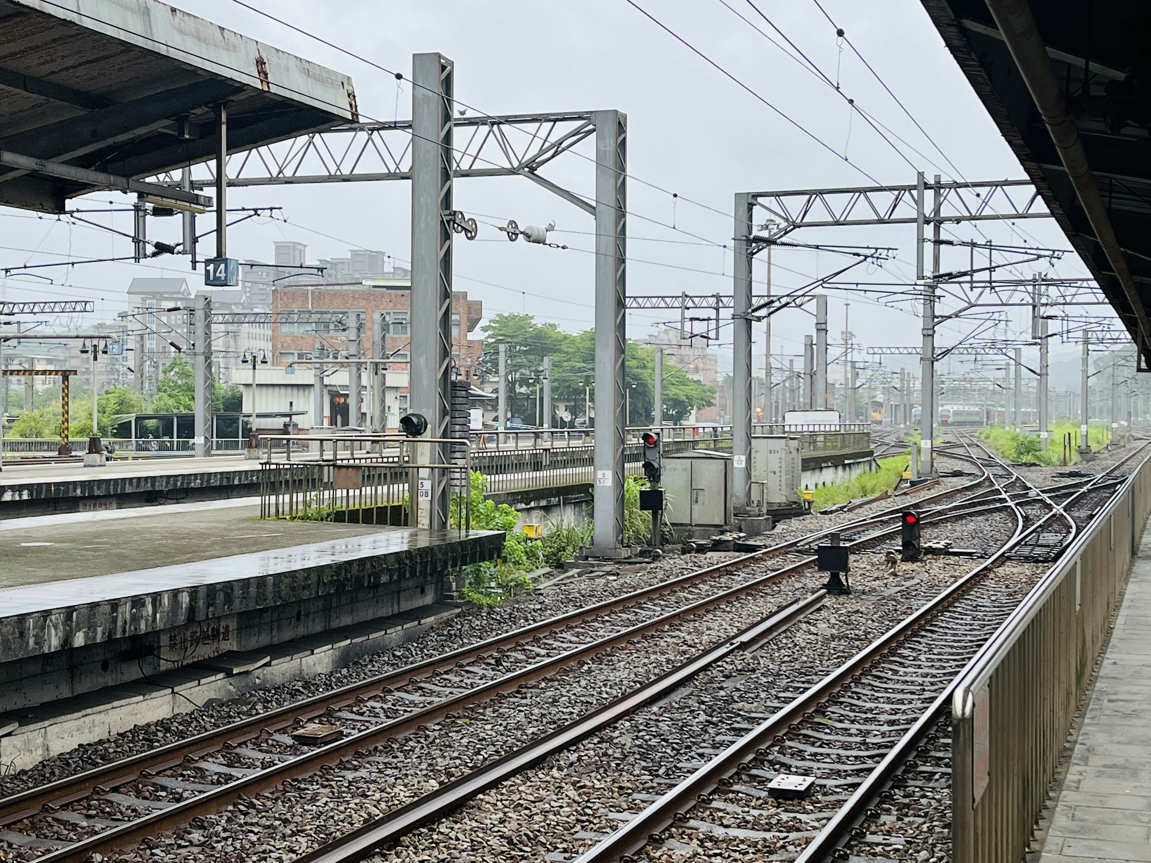 a man standing on a train track next to a train station