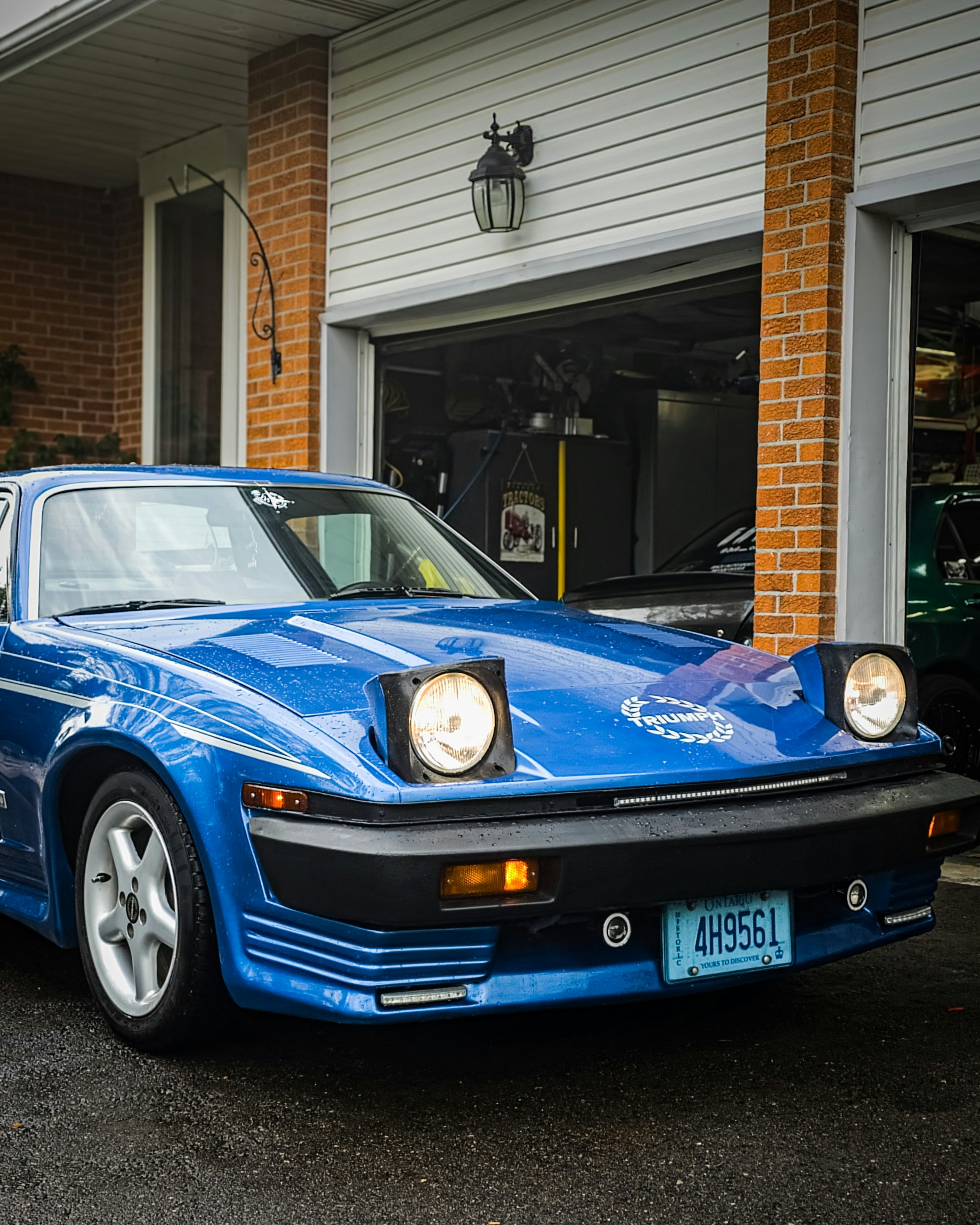 a blue car parked in front of a building