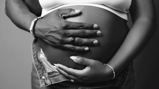 a pregnant woman holding her belly in her hands