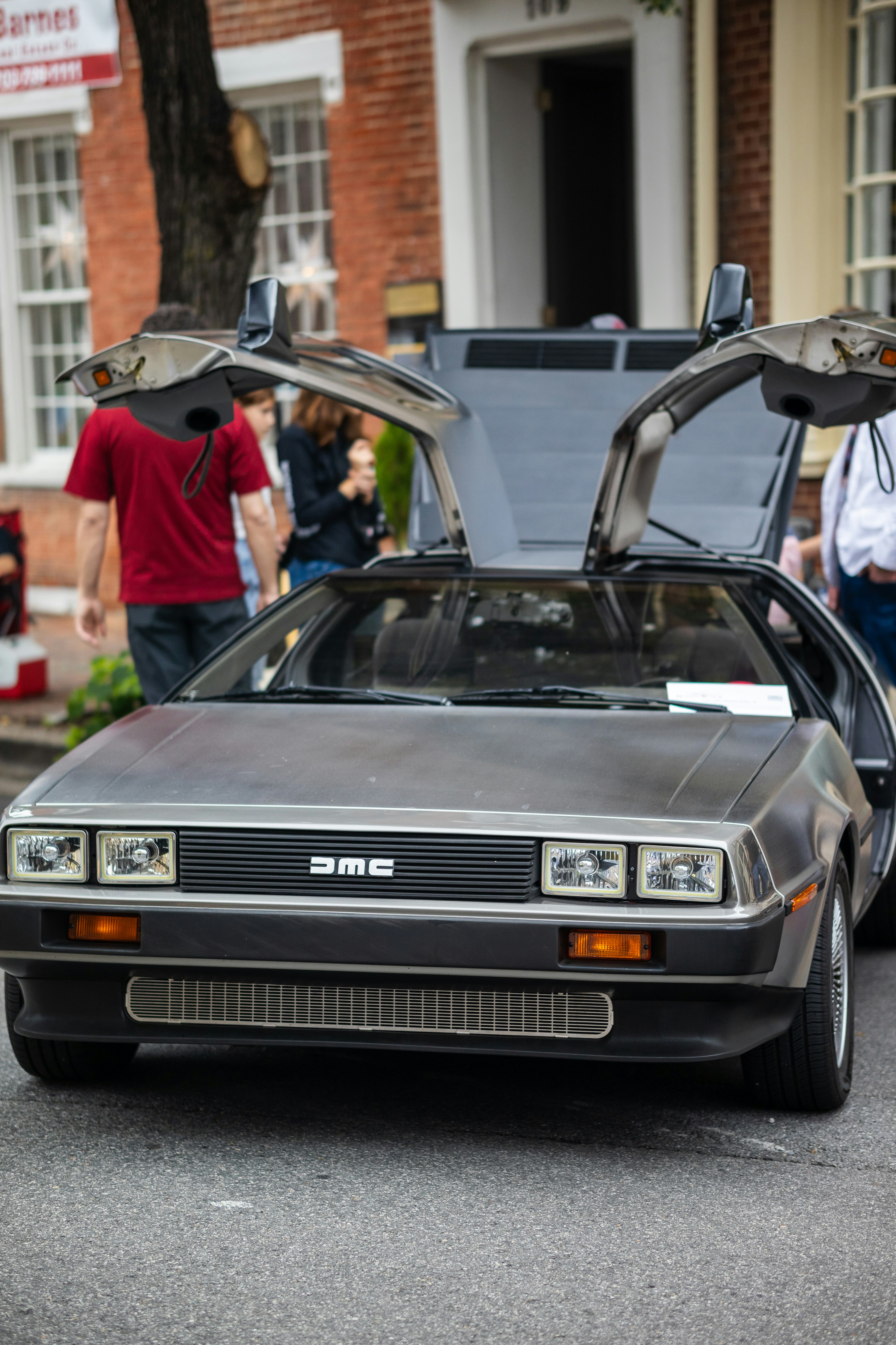 a car with its hood open on the street