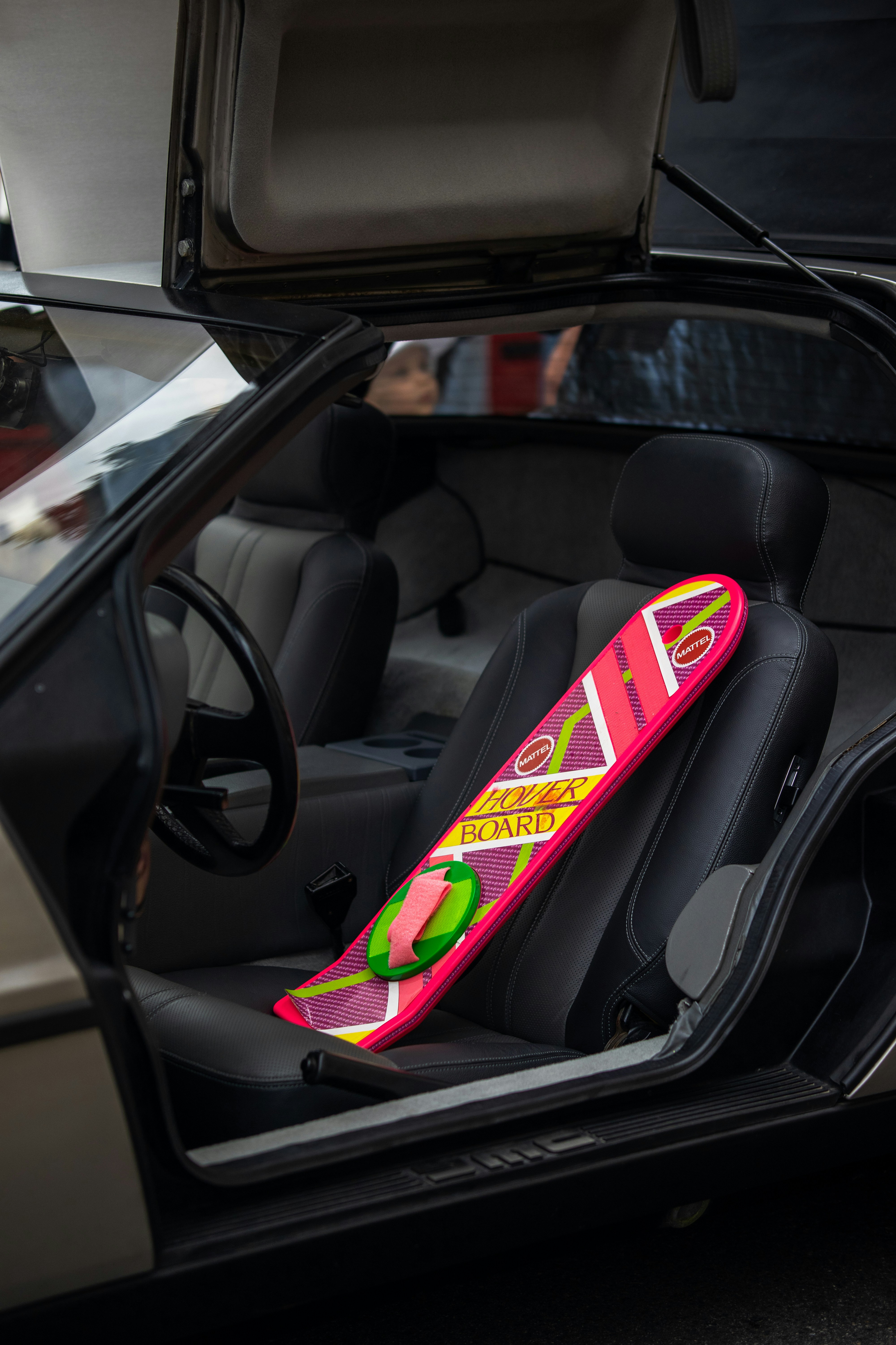 a pink snowboard sticking out of the back of a car