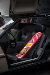 a pink snowboard sticking out of the back of a car