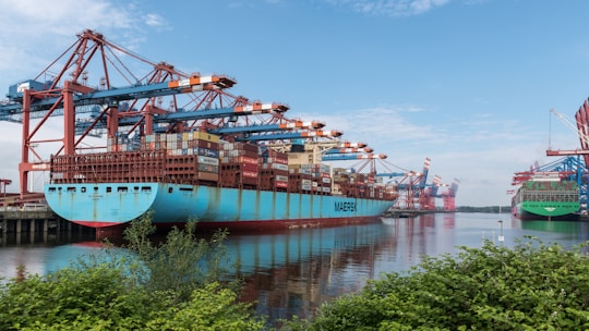 a large blue boat sitting next to a dock