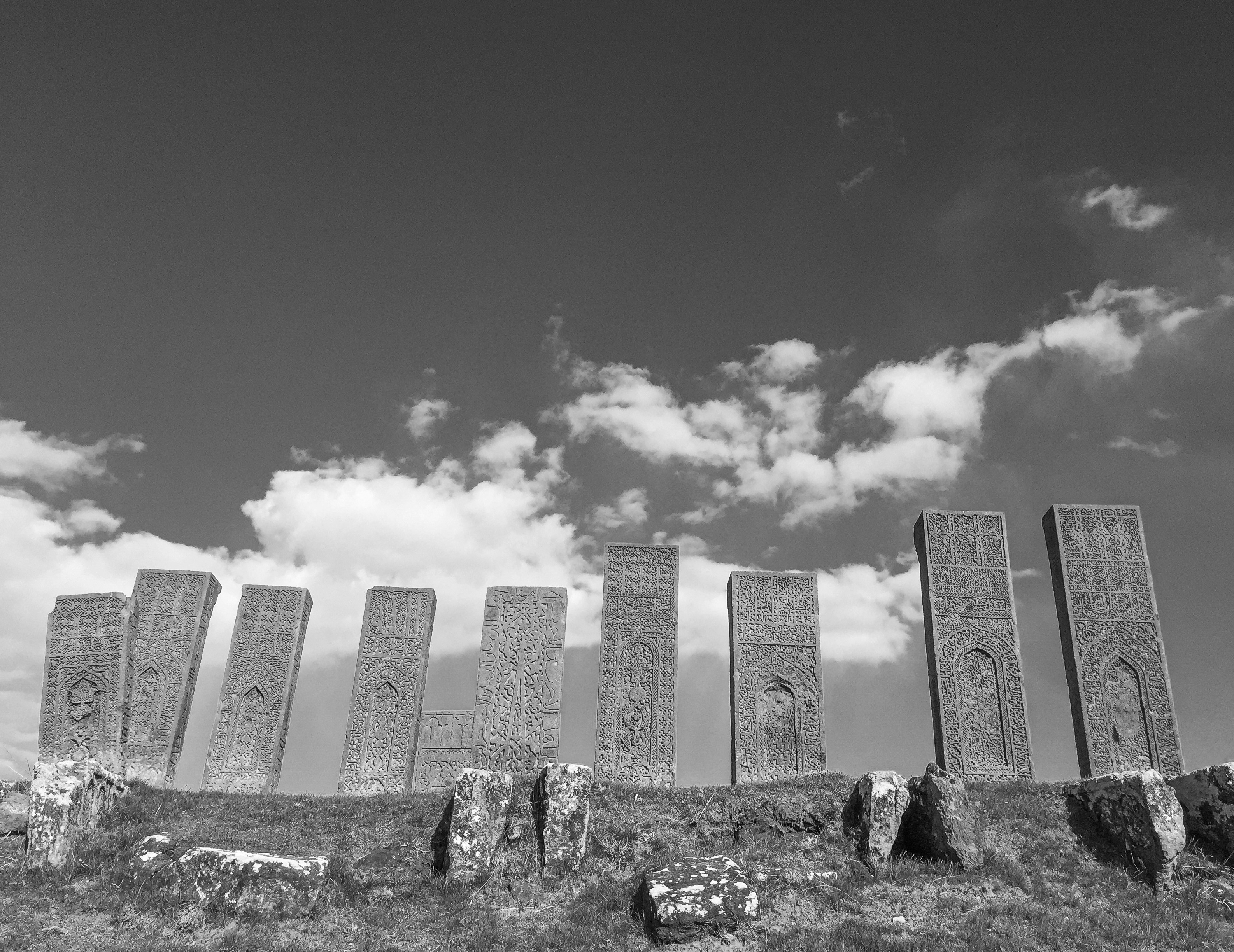 a black and white photo of a stone fence