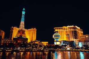 the eiffel tower is lit up at night