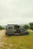 a van is parked on a dirt road