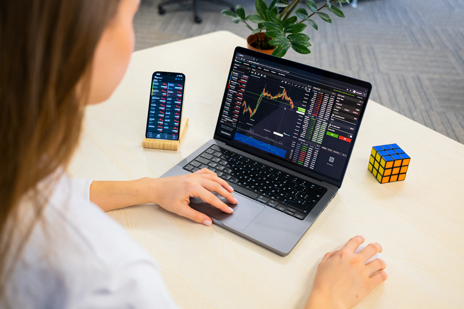 A crypto market researcher reviewing charts on a laptop