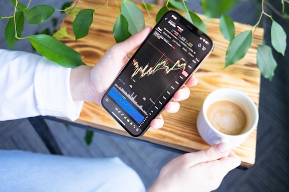 a person holding a cell phone in their hand