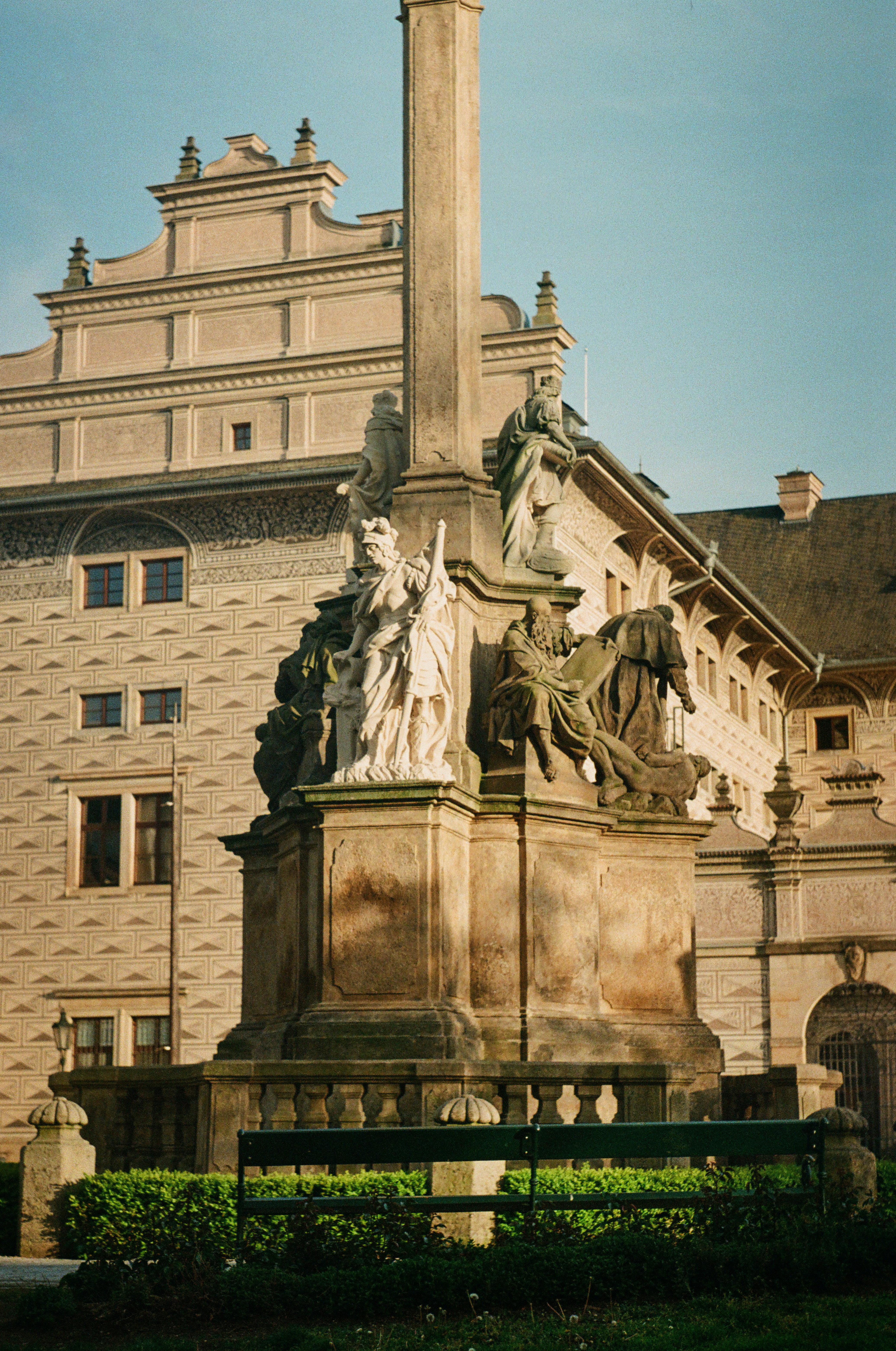 a statue in front of a building with a clock tower