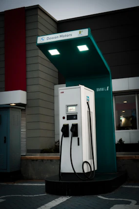 a green and white gas pump next to a building