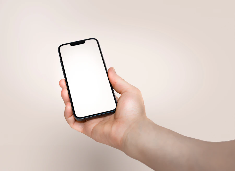 Hand holding a phone, ready to tap into a digital business card
