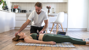 a woman laying on the floor in front of a man