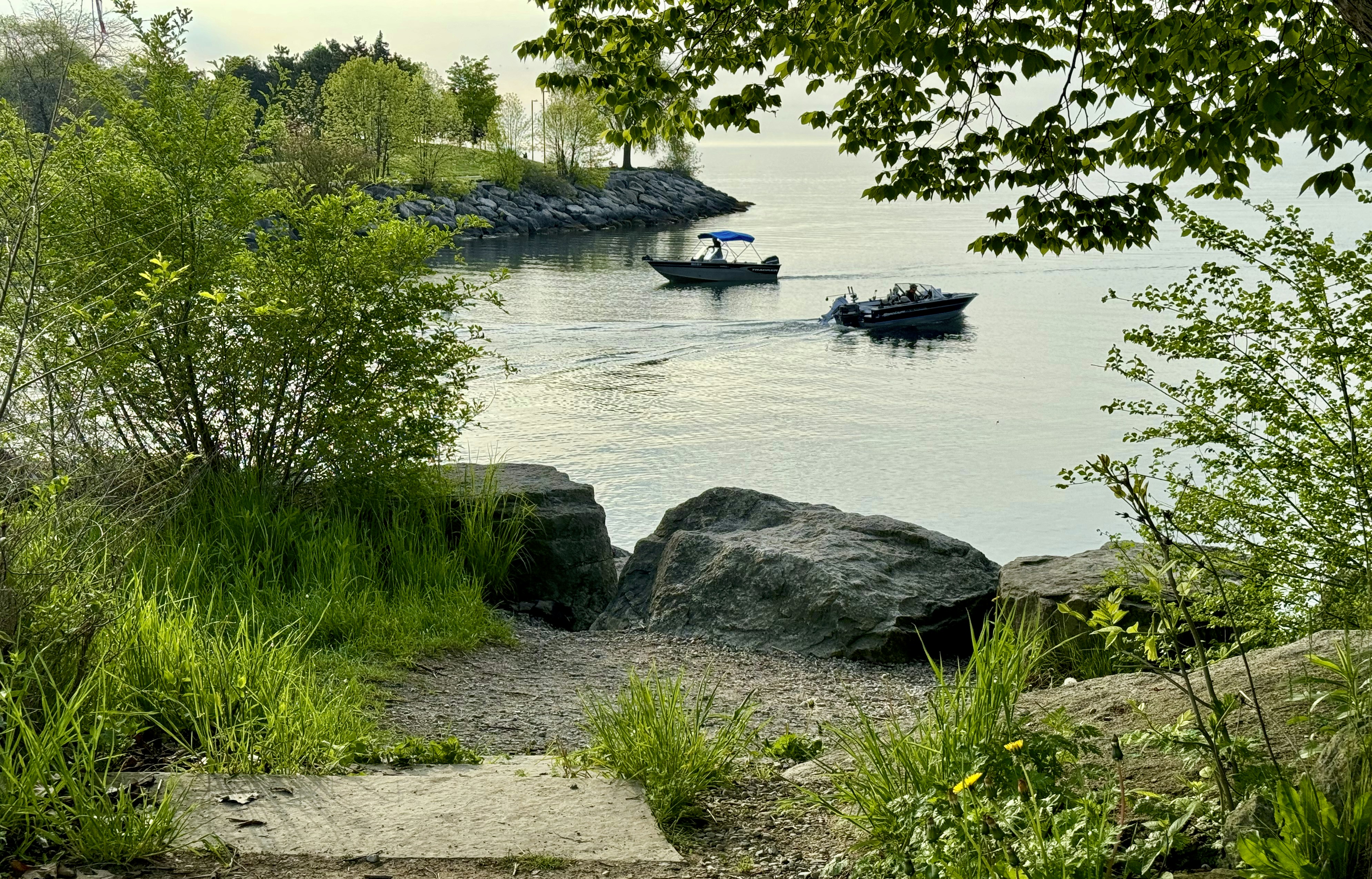 a couple of boats floating on top of a lake