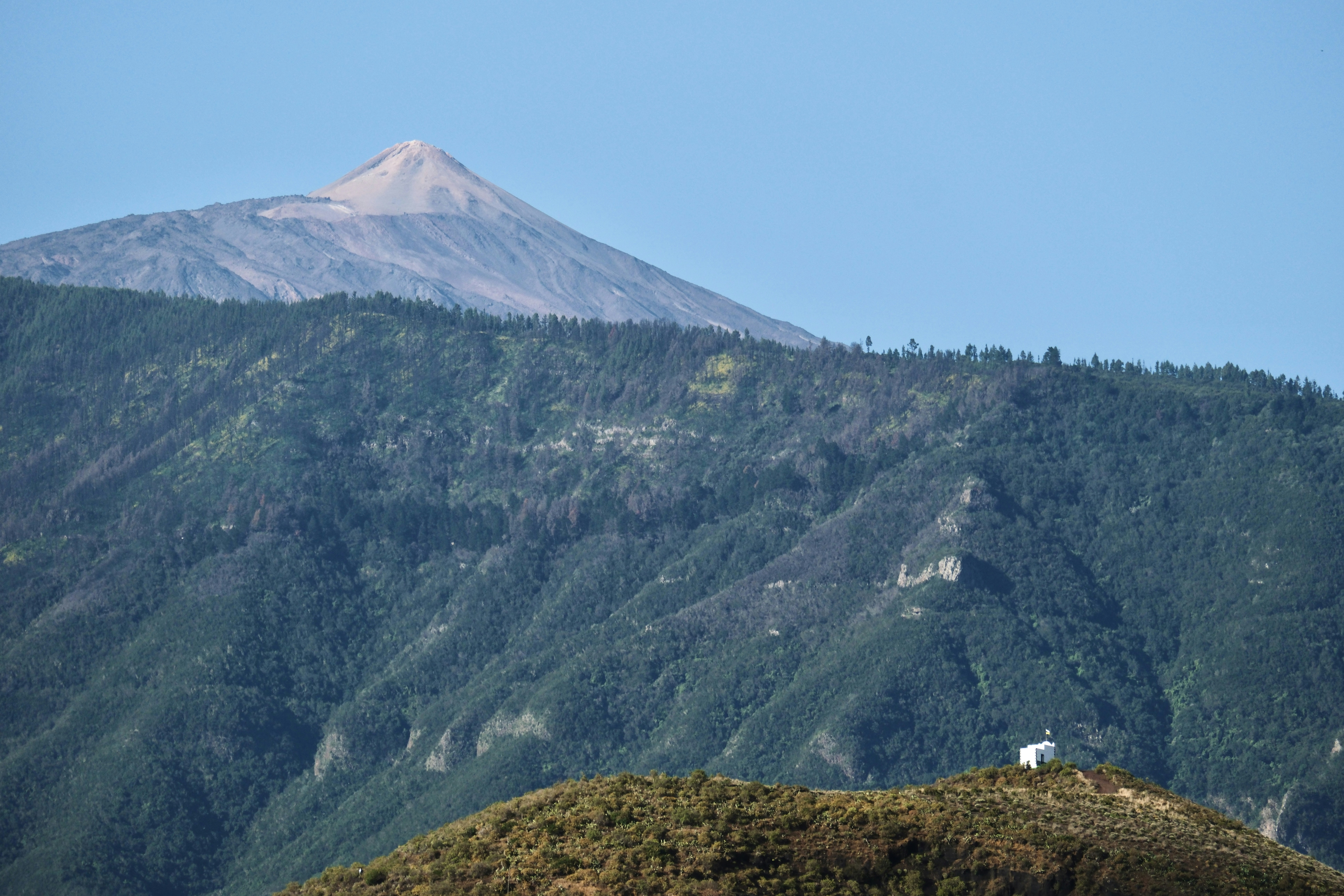 a mountain with a house on top of it