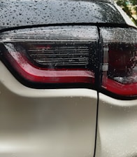 a close up of the tail lights of a white car