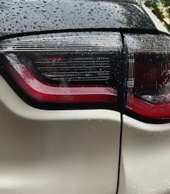 a close up of the tail lights of a white car