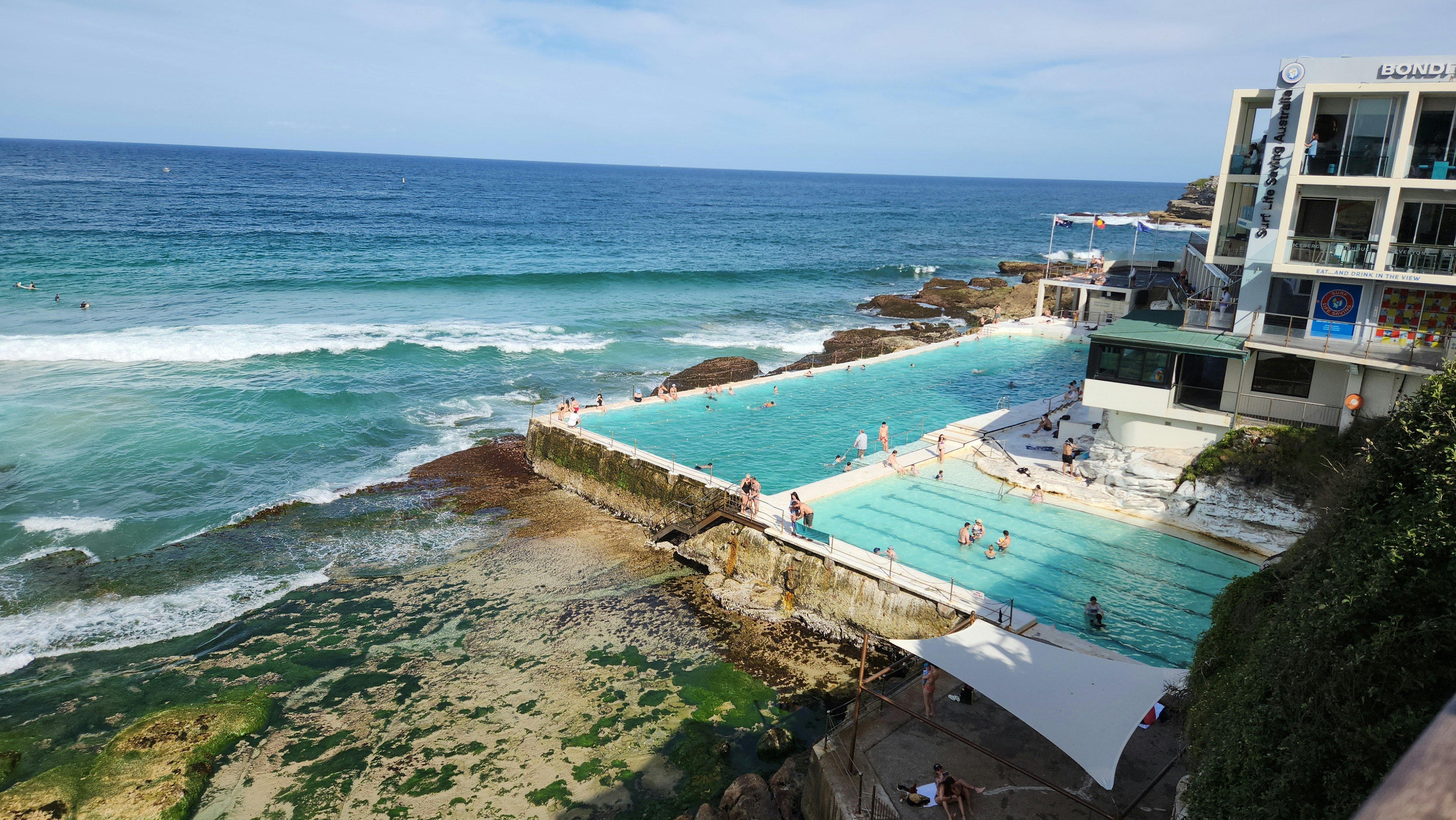 a large swimming pool next to the ocean