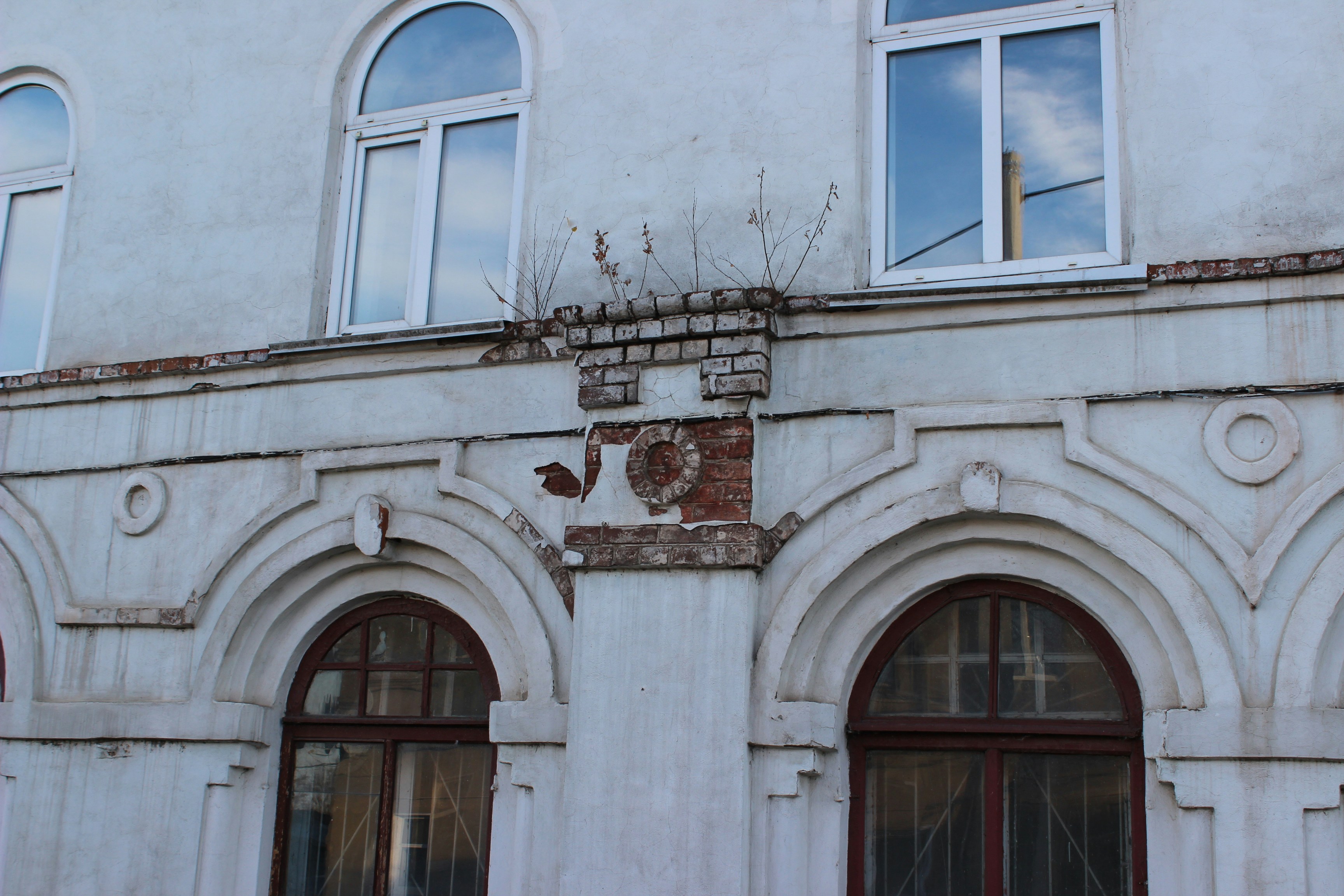 a white building with arched windows and a clock