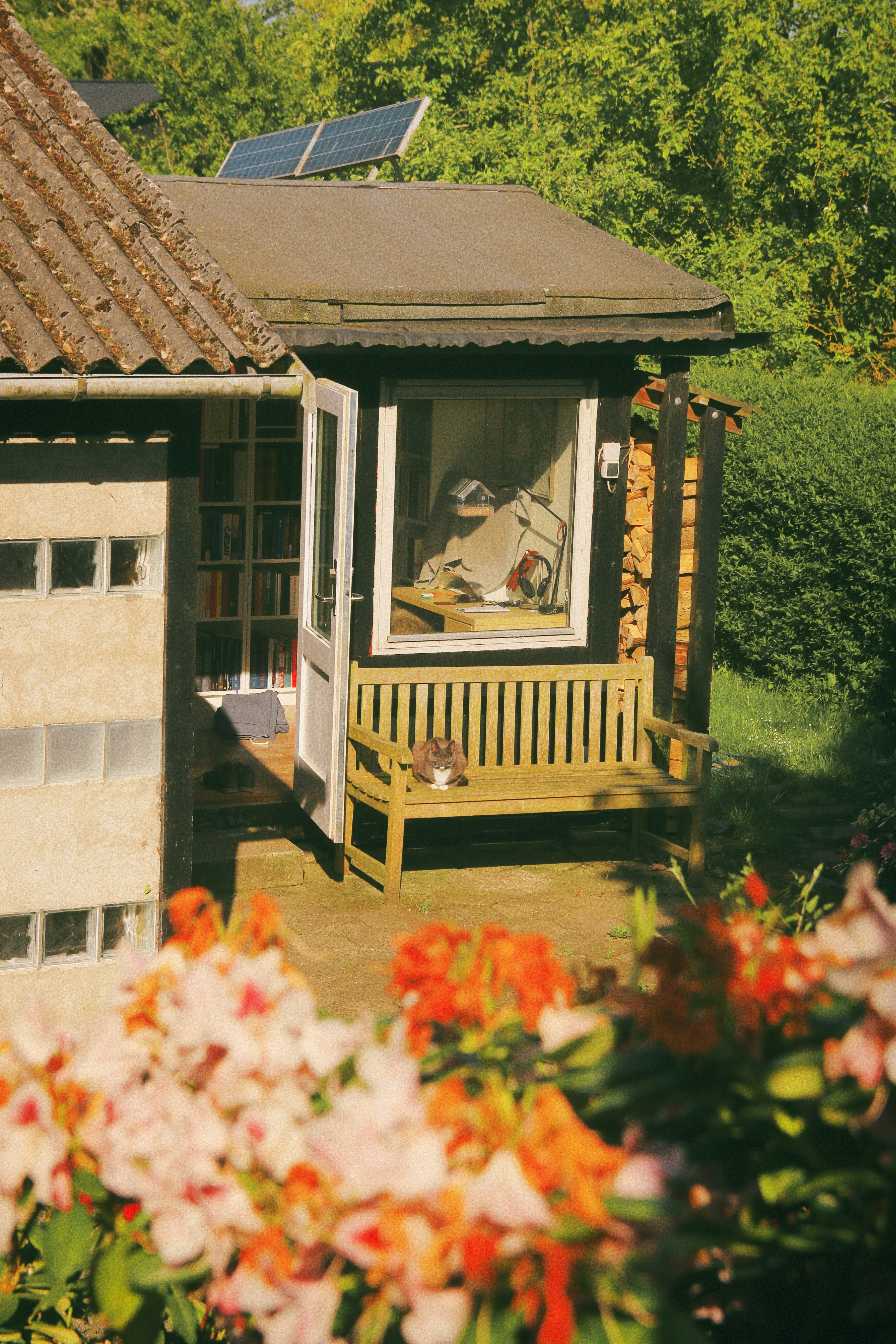 a wooden bench sitting in front of a building