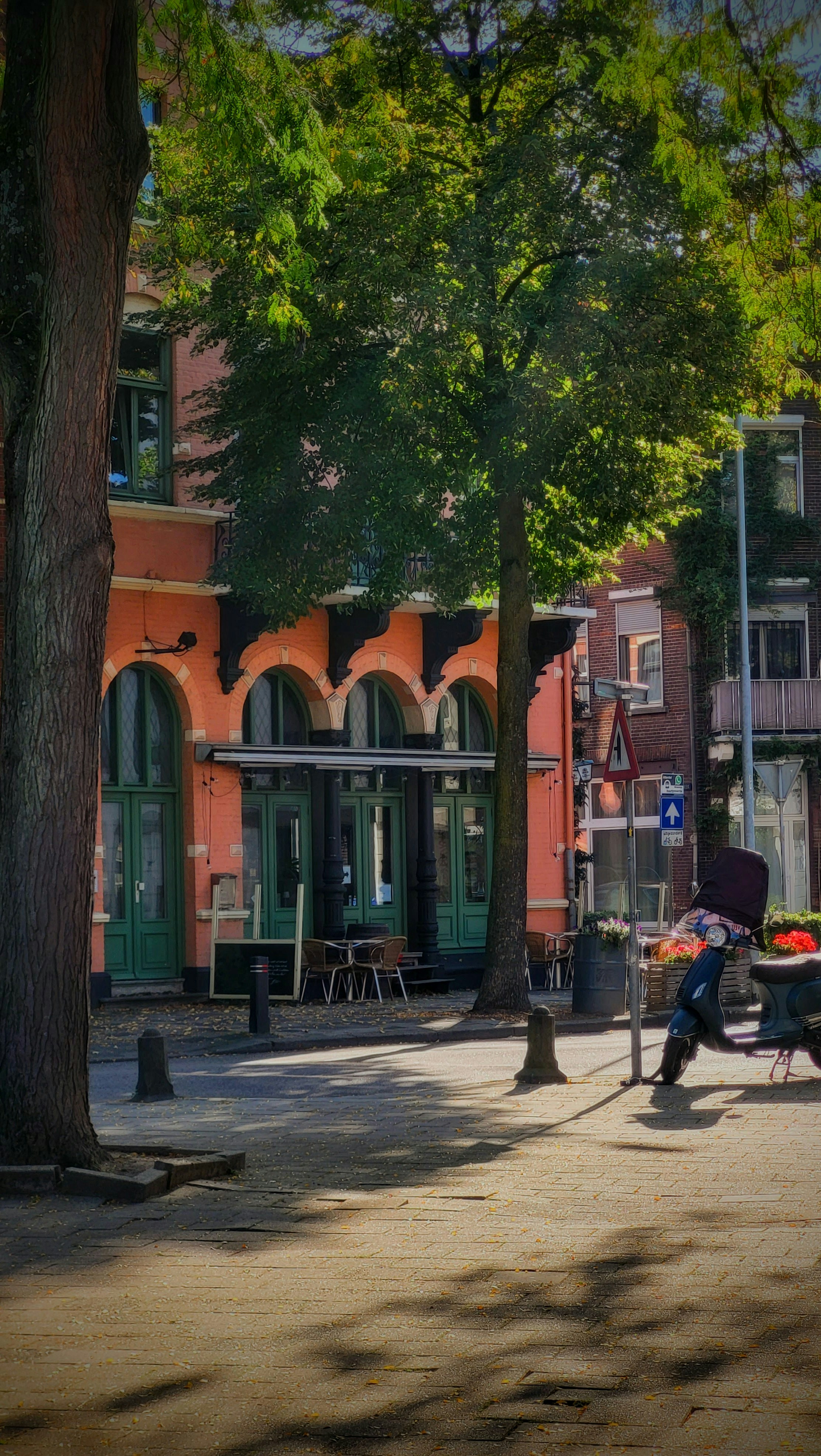 a person sitting on a bench in front of a building