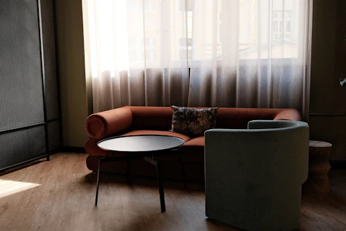 A small couch and armchair in a counselling office