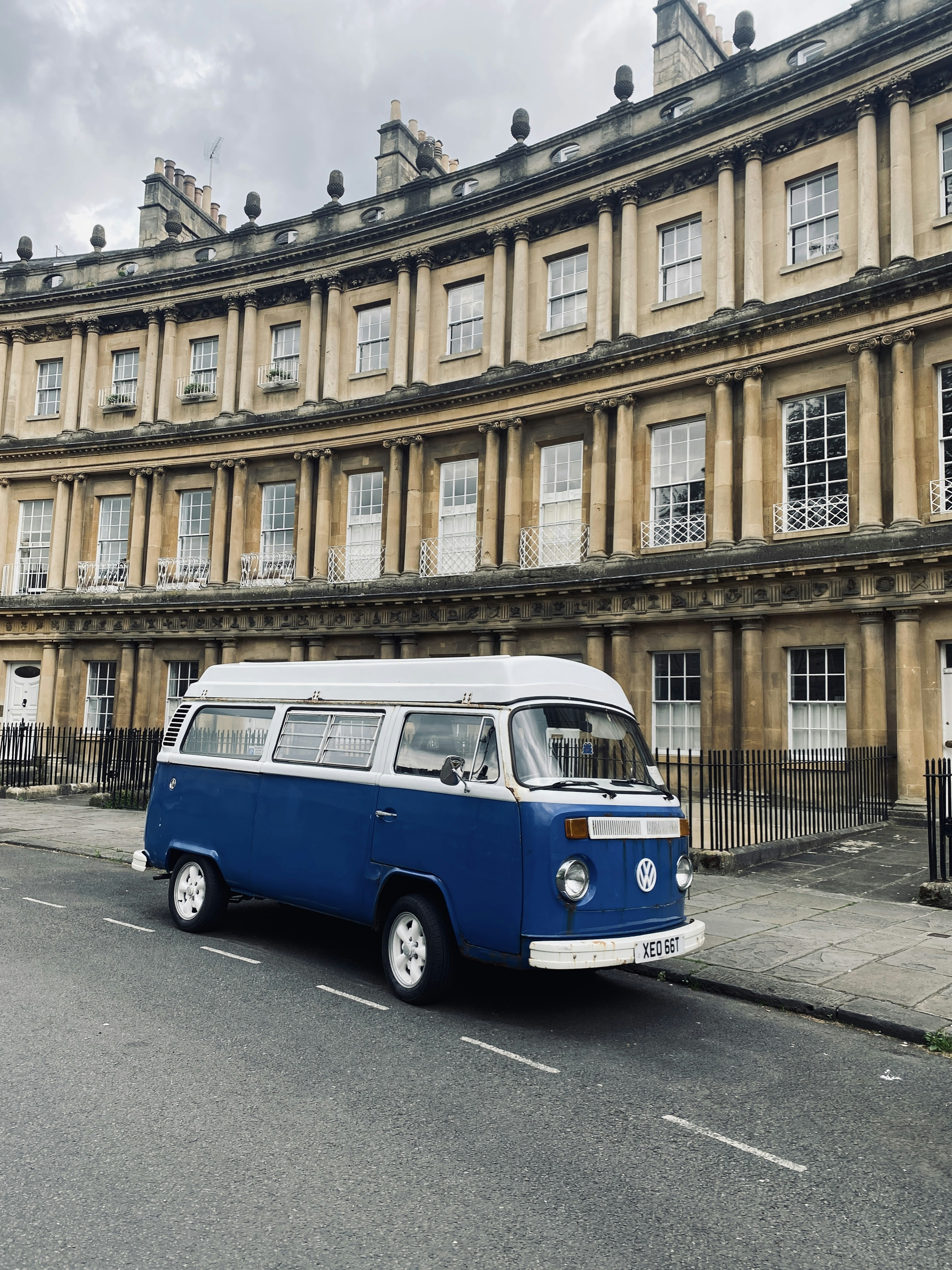 a blue and white van parked in front of a building