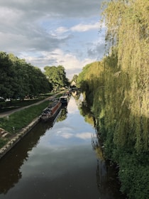a narrow canal with a few boats on it