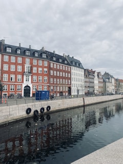 a row of buildings next to a body of water