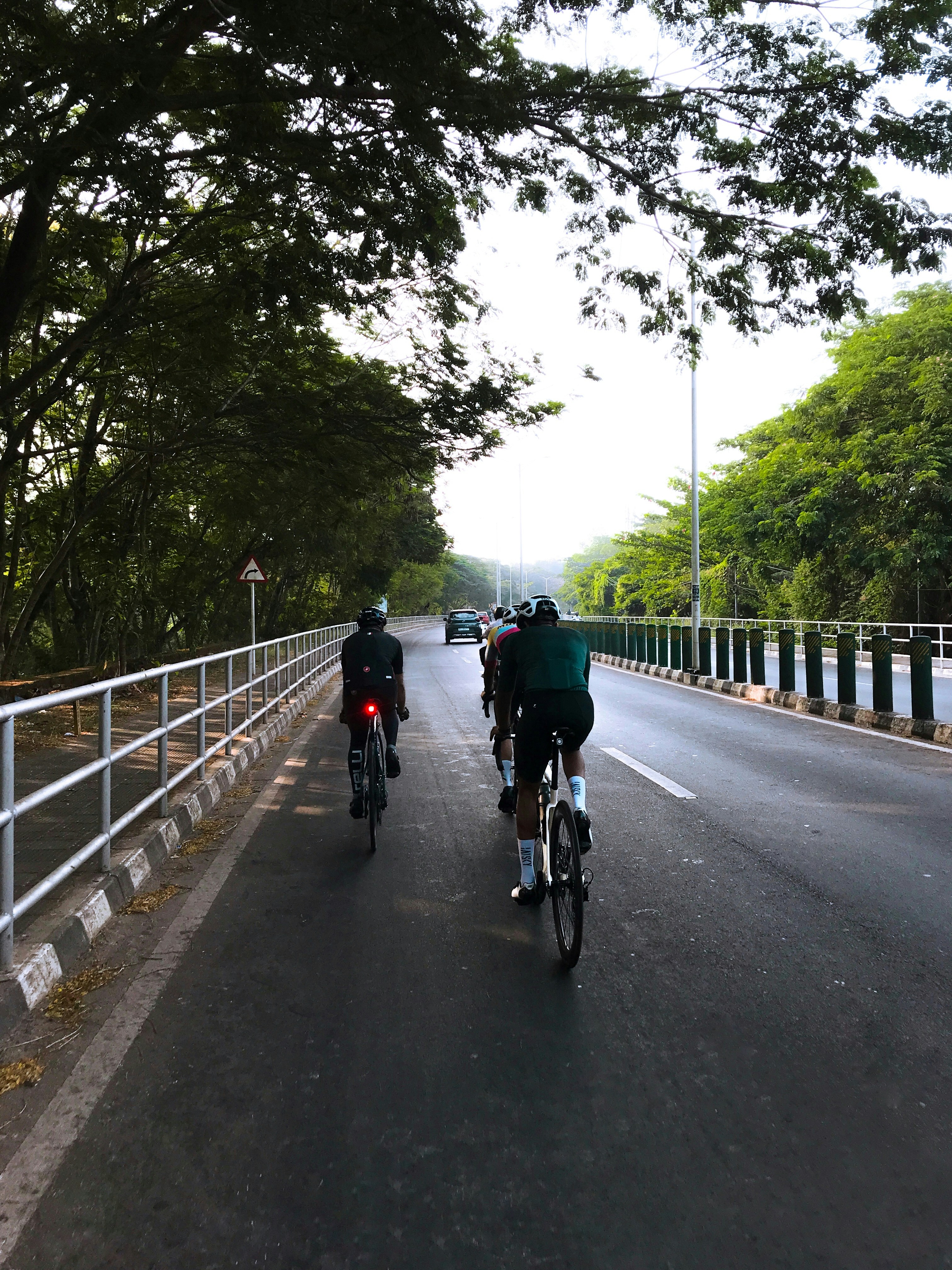 a couple of people riding bikes down a street