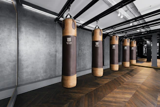 a row of punching bags in a gym