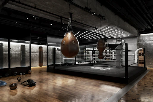 a boxing ring with a pair of boxing gloves hanging from the ceiling