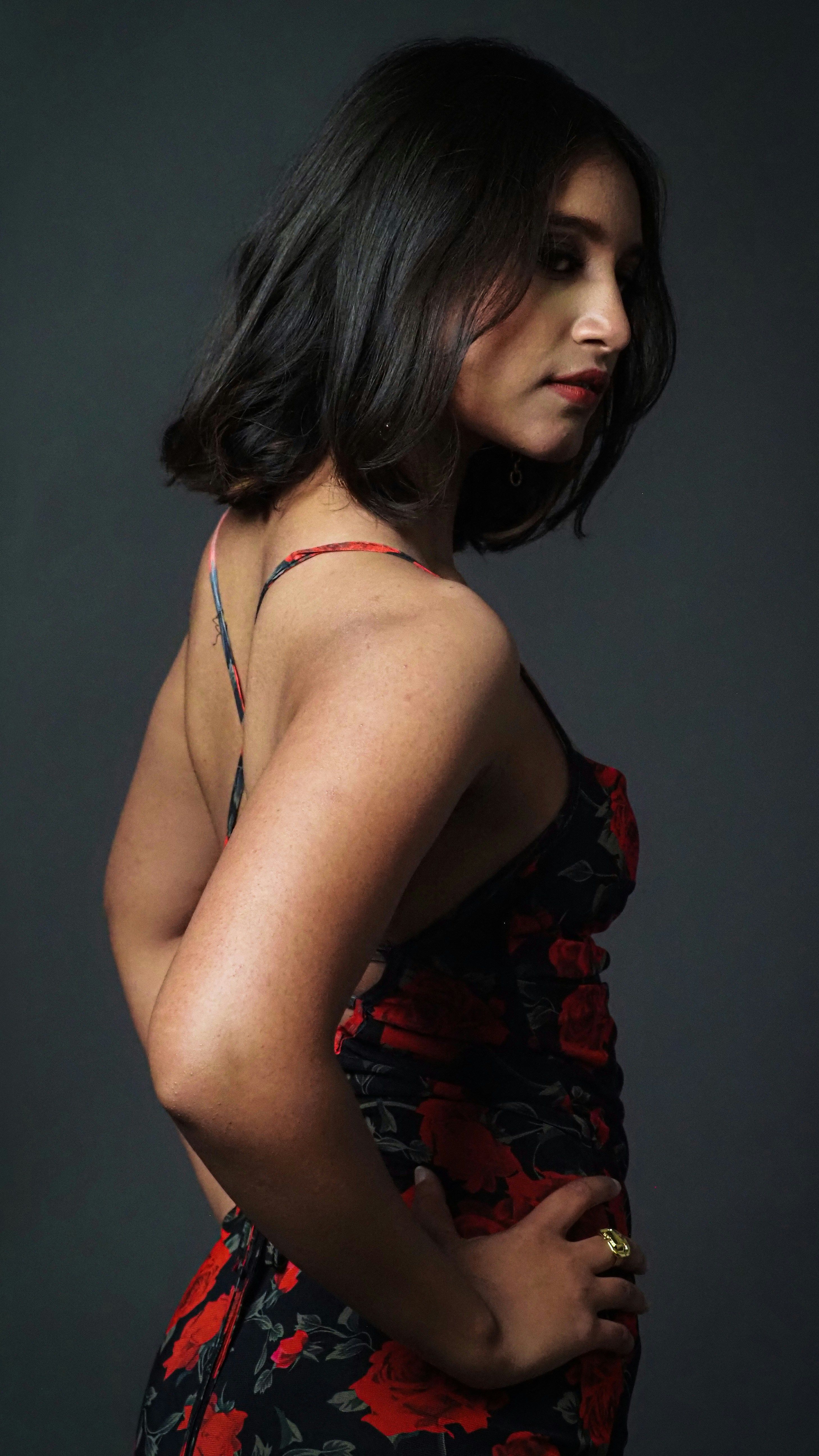 a woman in a floral dress poses for a picture