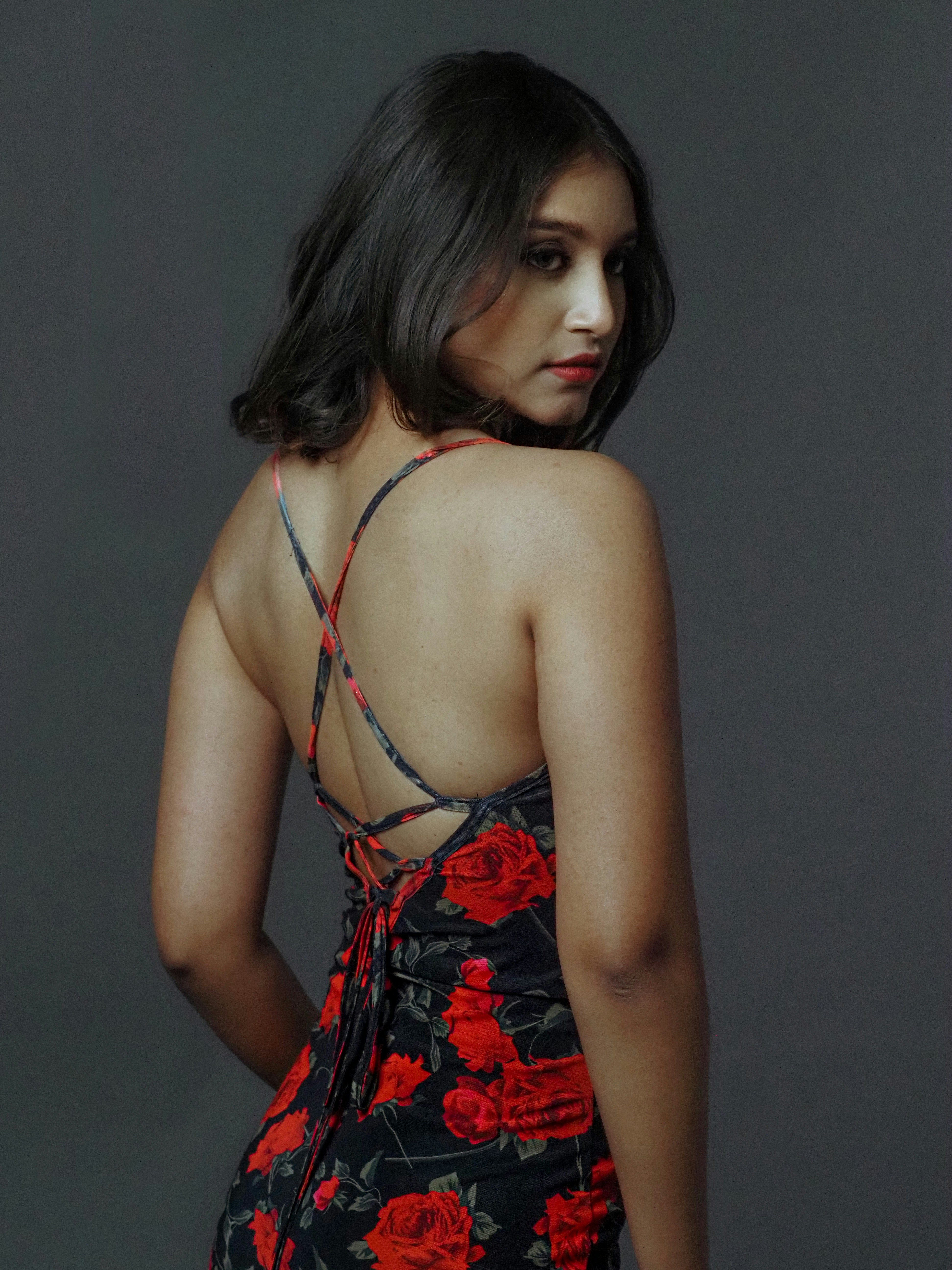 a woman in a floral dress is posing for a picture