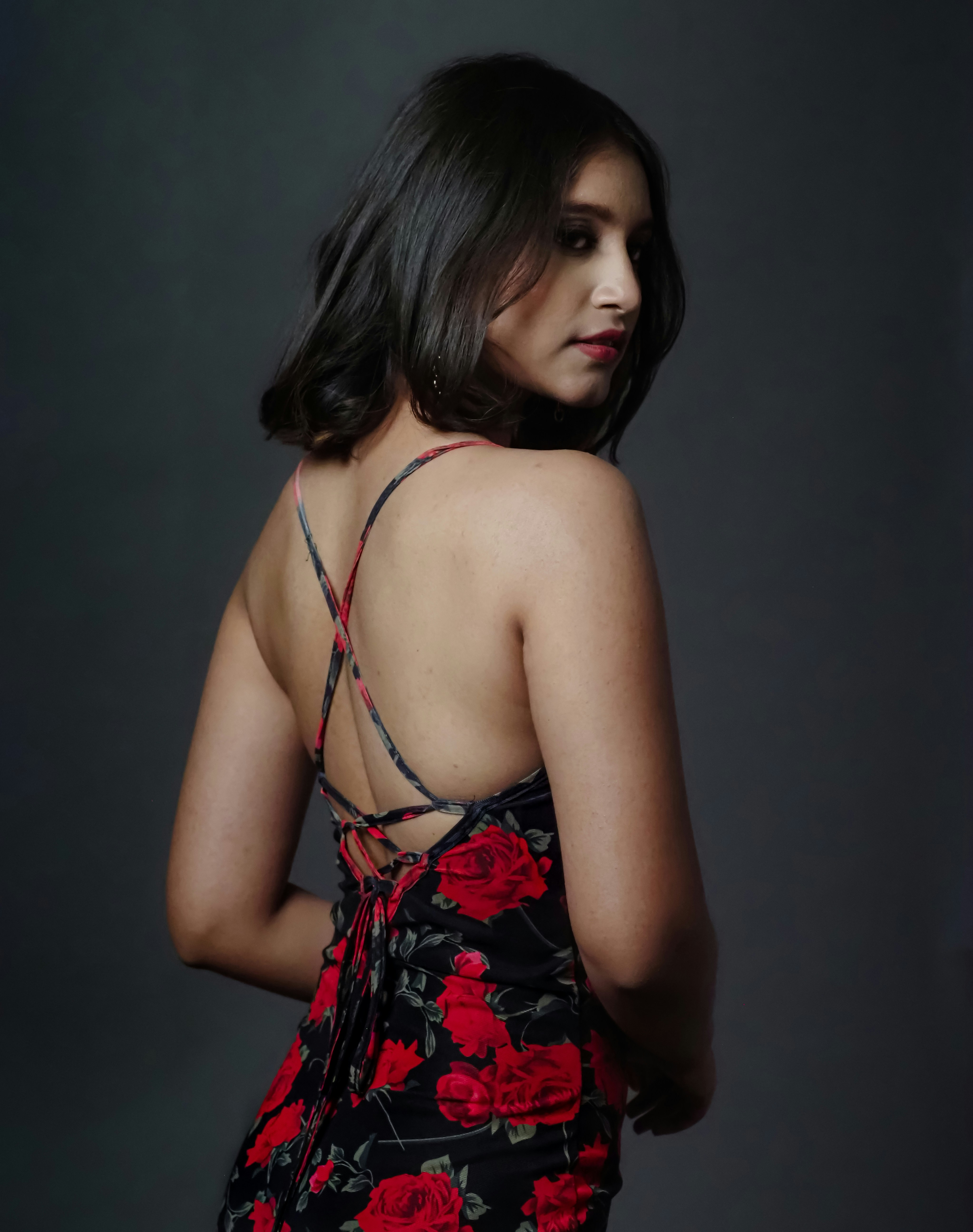 a woman in a floral dress is posing for a picture