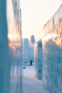 a person walking down a street next to tall buildings