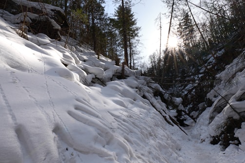 a man riding skis down a snow covered slope