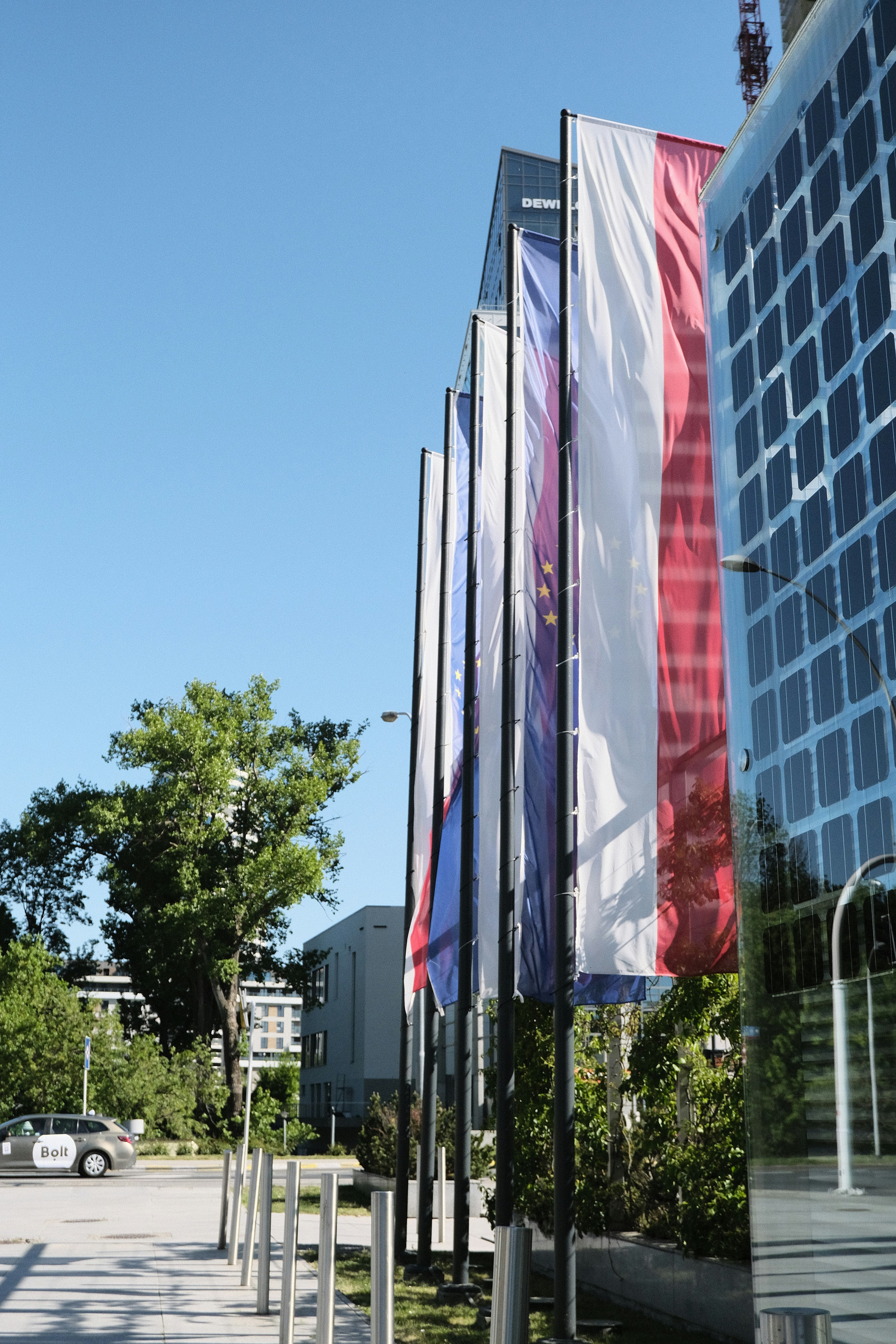 a row of flags in front of a building