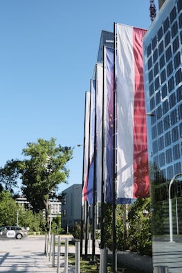 a row of flags in front of a building