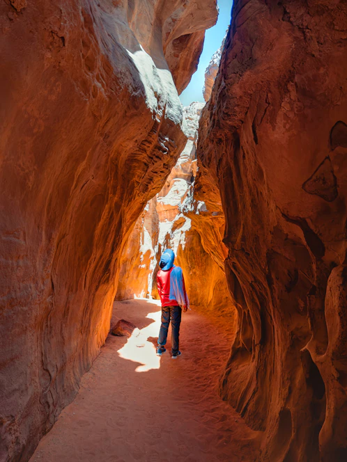 a couple of people that are walking through some rocks