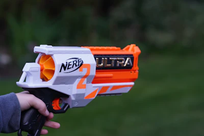 a person holding a nerf gun in their hand