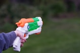a person holding a toy gun in their hand