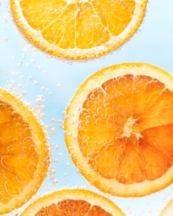 a group of sliced oranges sitting on top of a table