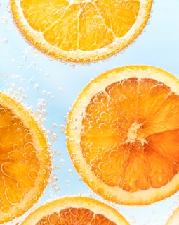 a group of sliced oranges sitting on top of a table
