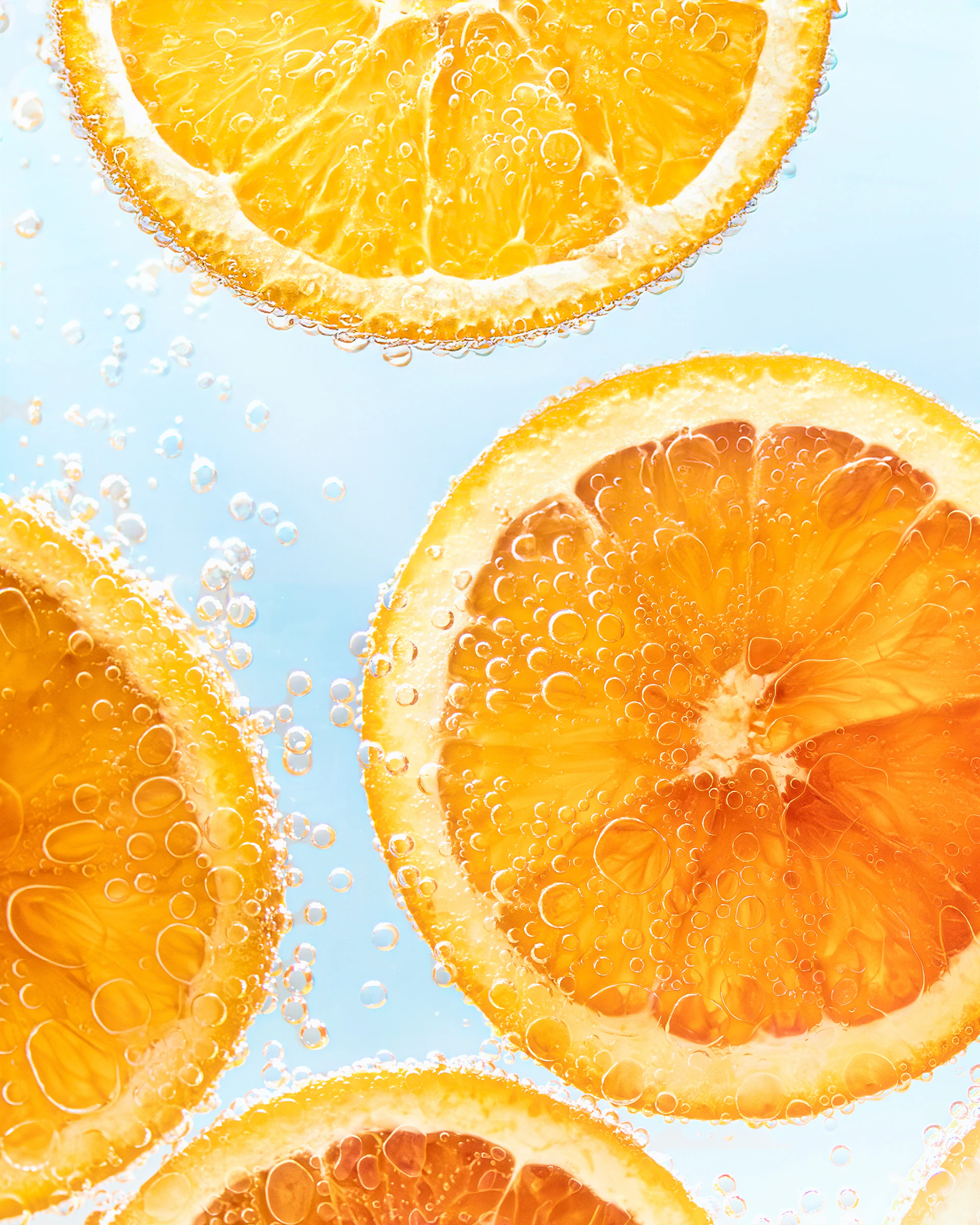 a group of sliced oranges sitting on top of a table