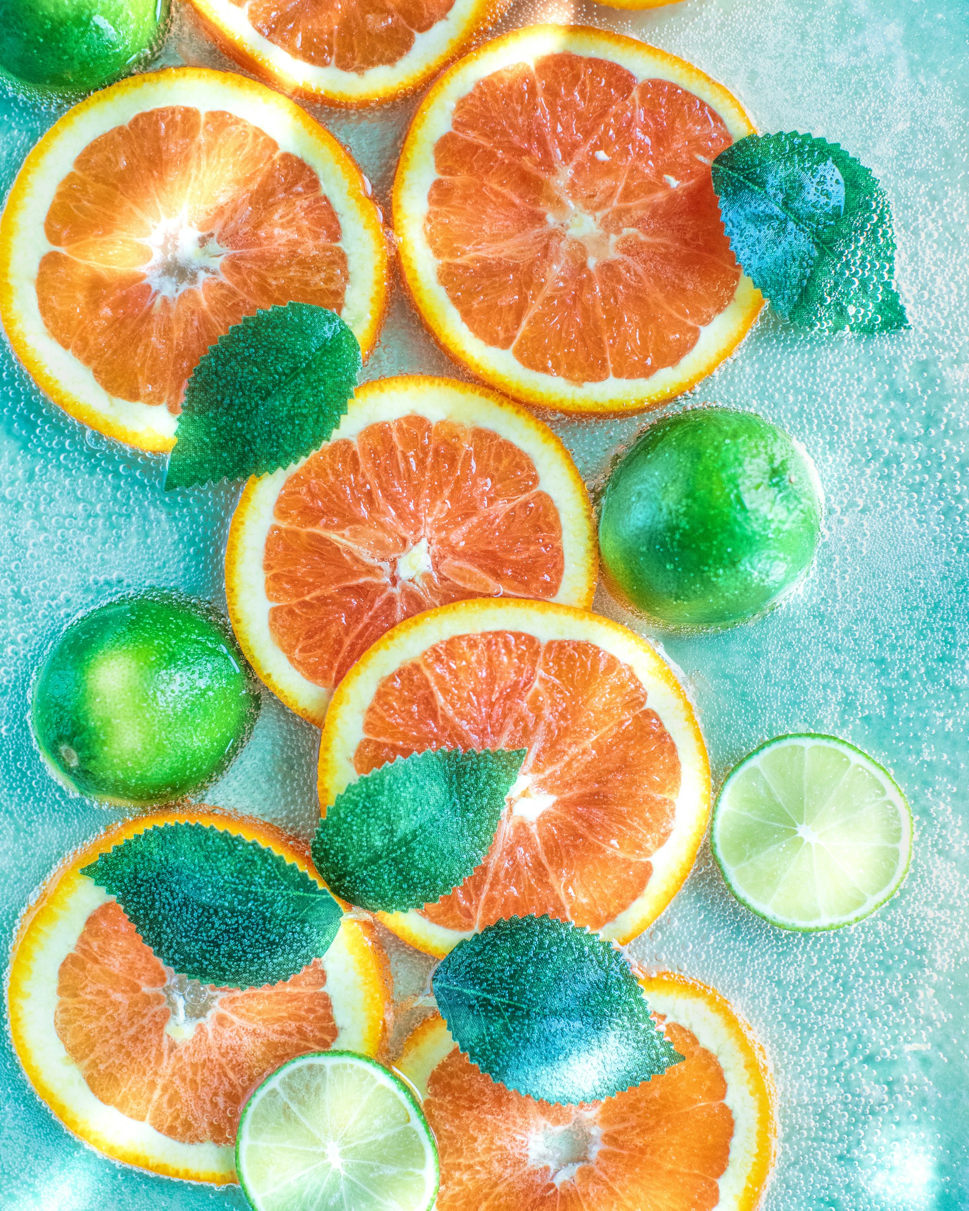 a bunch of oranges and limes on a table