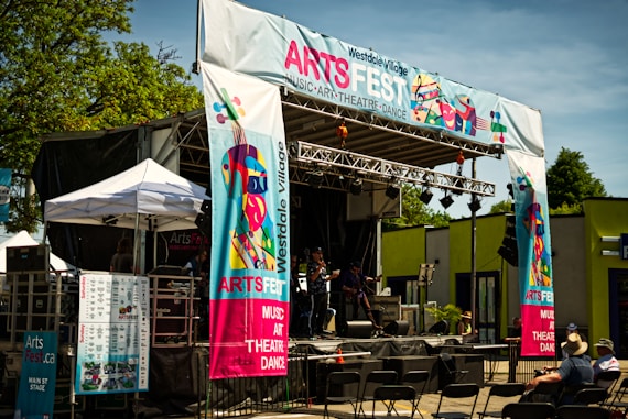 a stage set up for a concert with people sitting in chairs