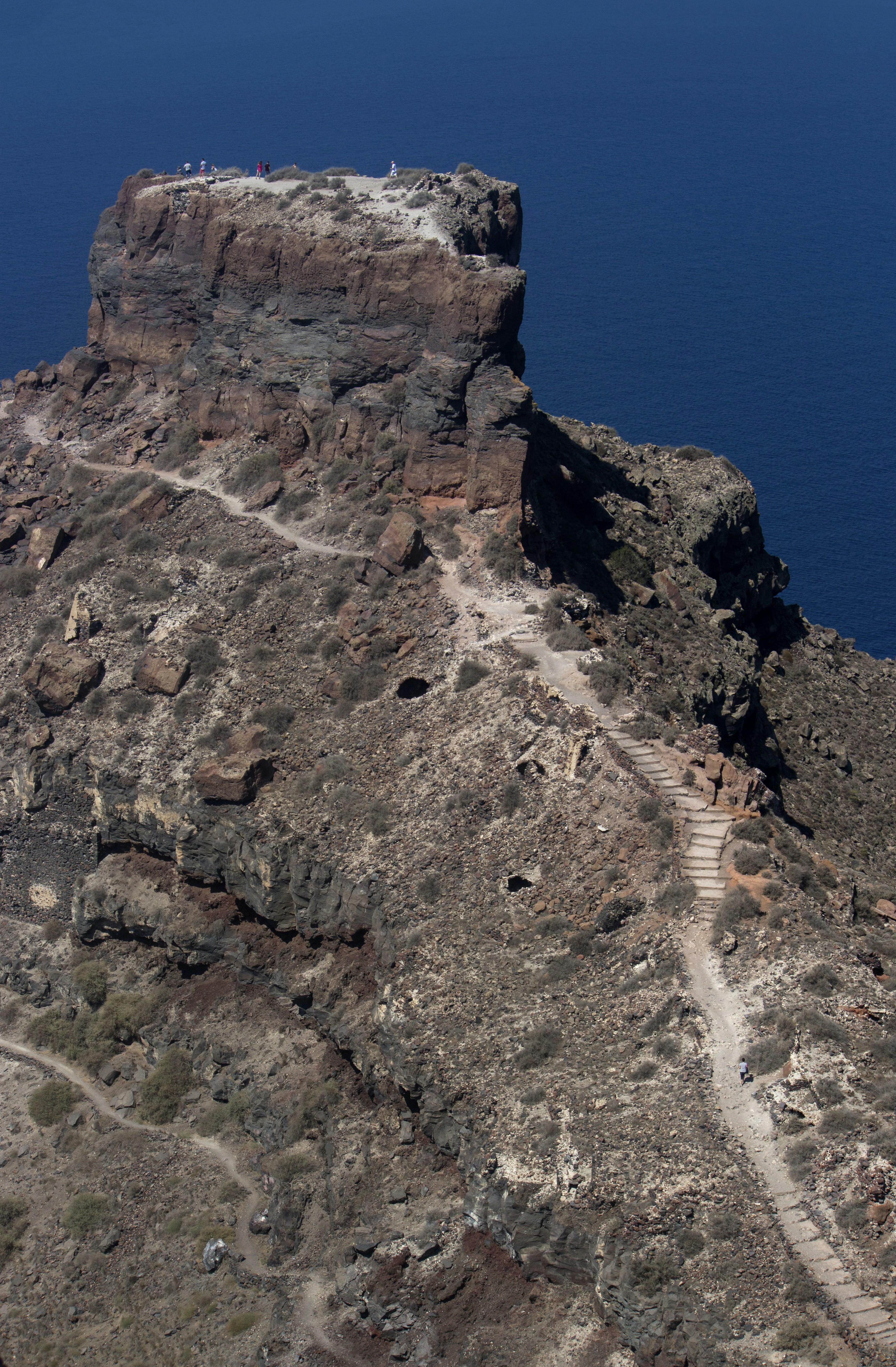a rocky cliff with a path leading to the top of it