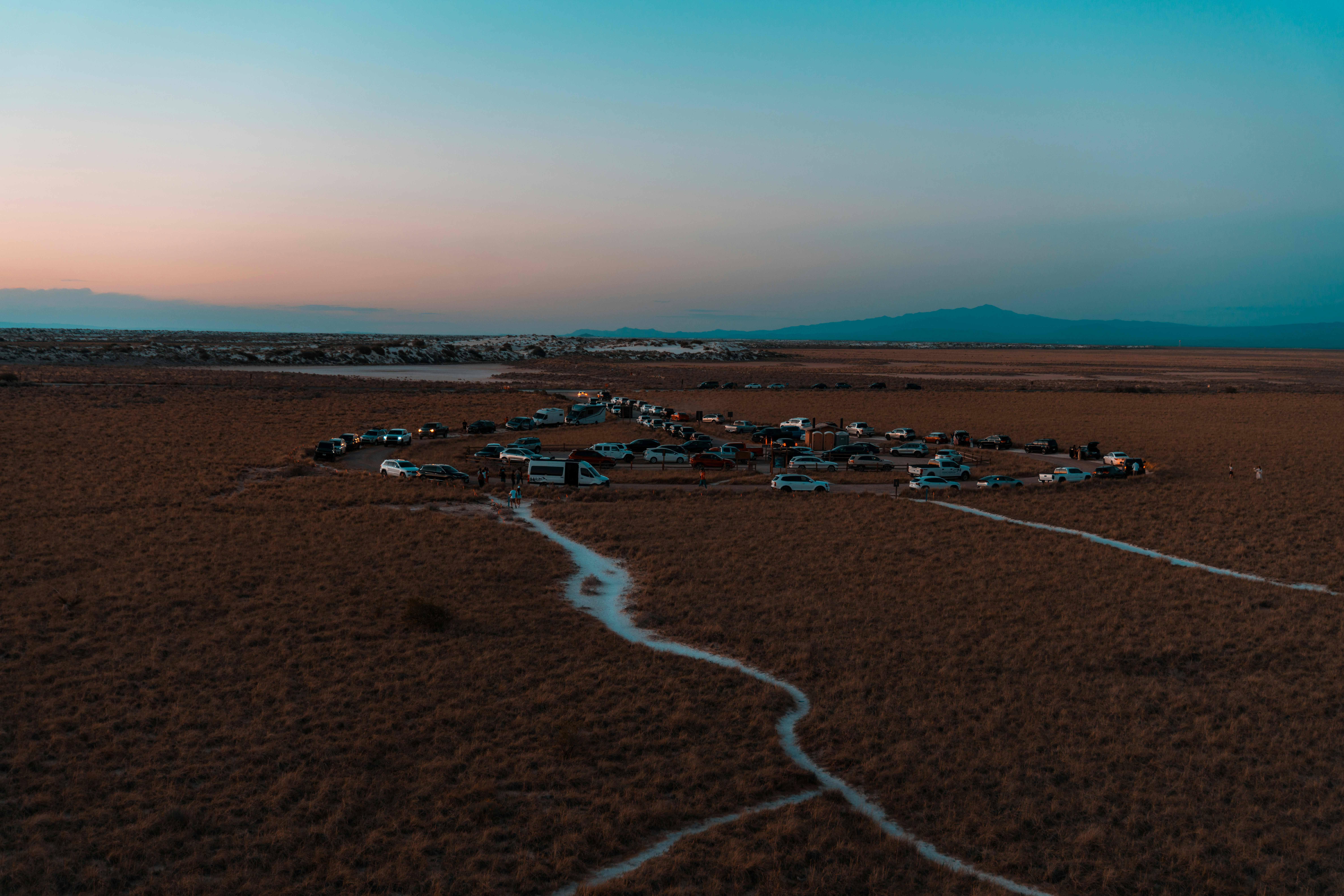 an aerial view of a desert with a river running through it